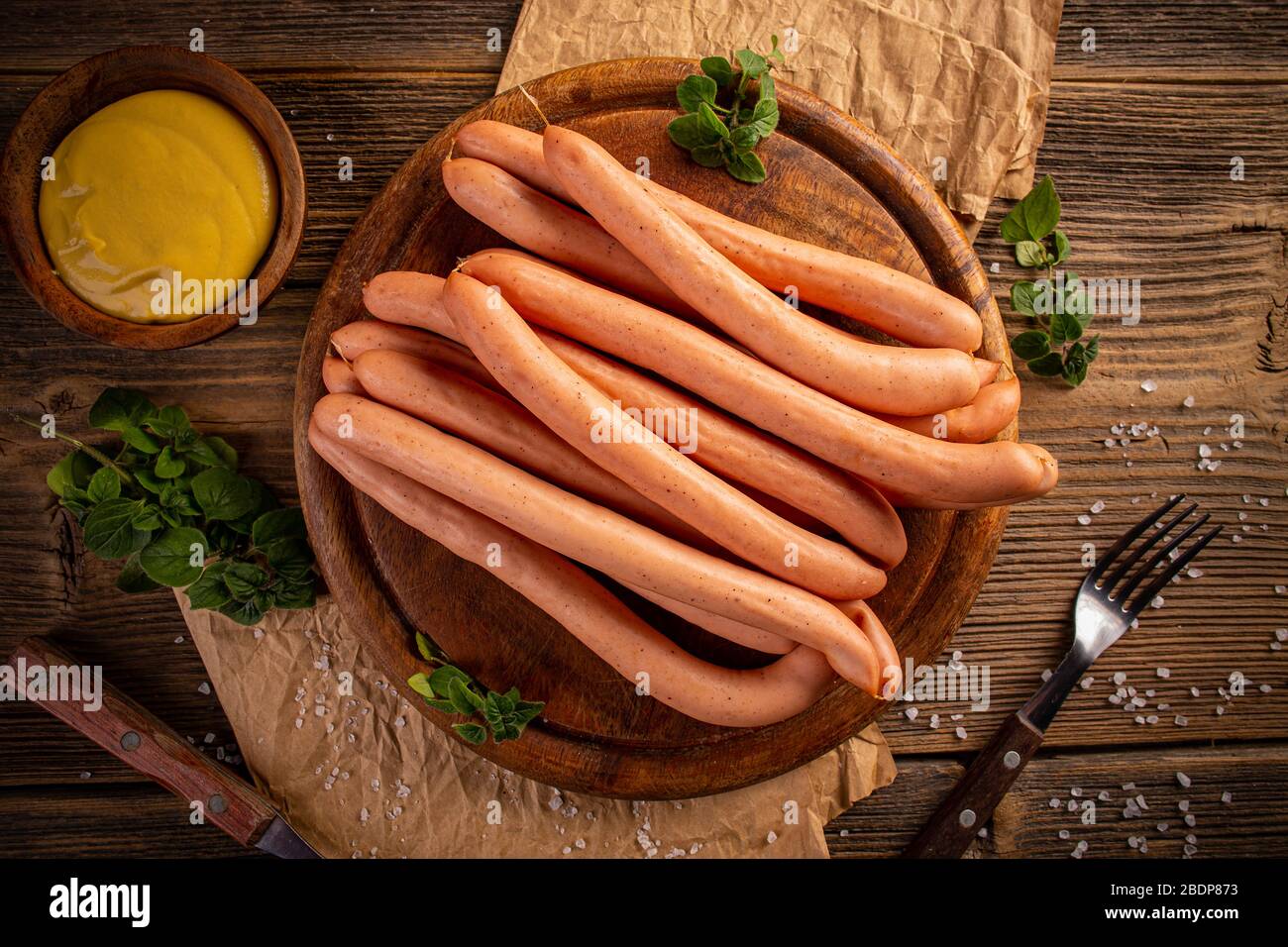 Frankfurter Sausage with mustard on rustic wooden cutting board Stock Photo