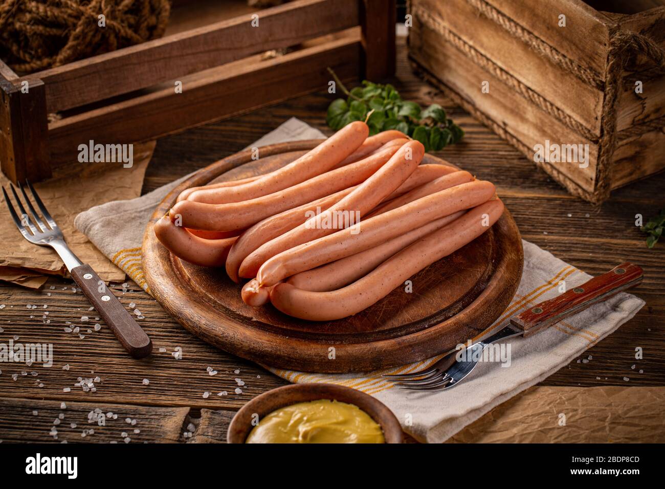 Fresh boiled Wiener sausages on wooden cutting board Stock Photo