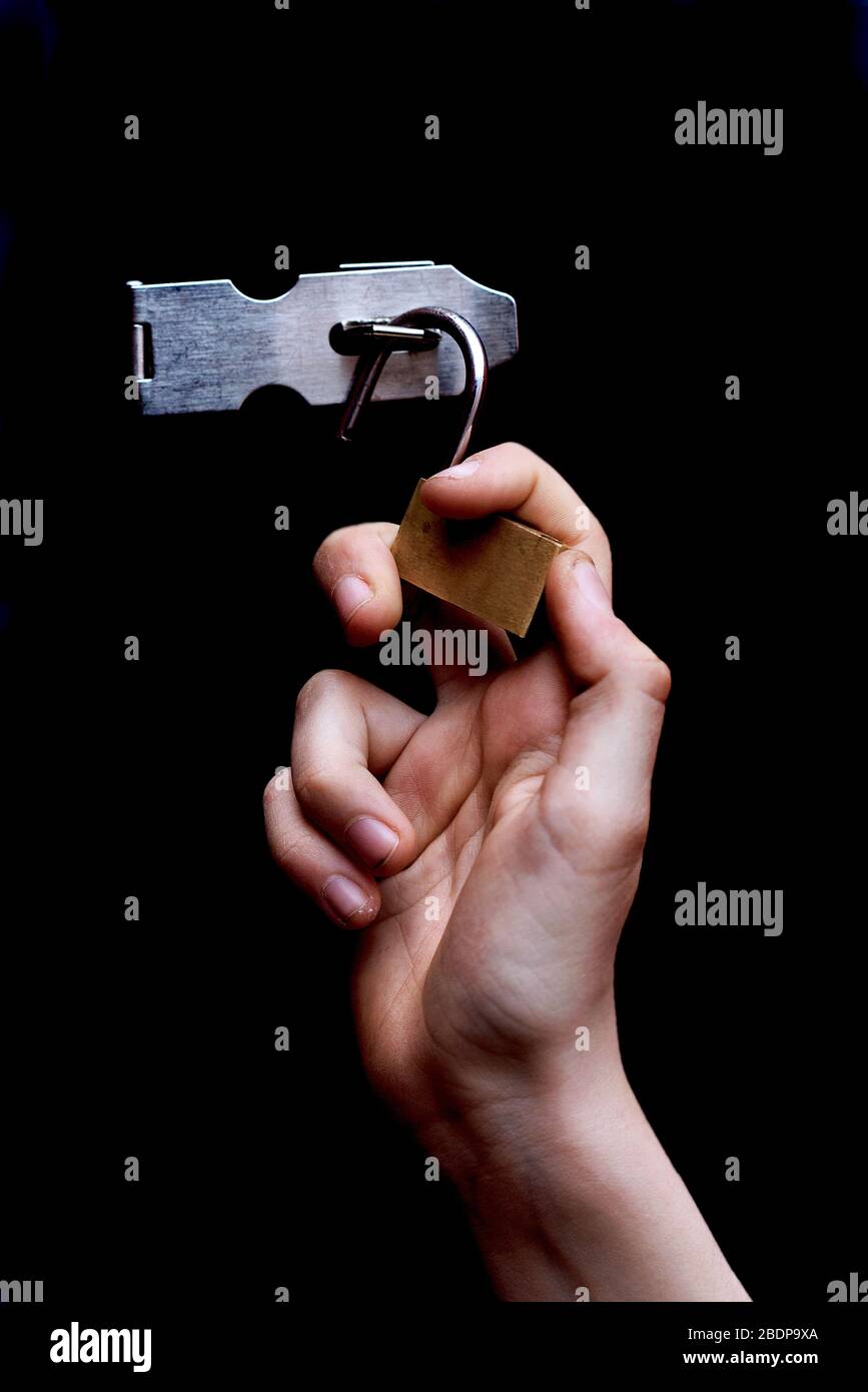 Hand removing padlock Stock Photo Alamy