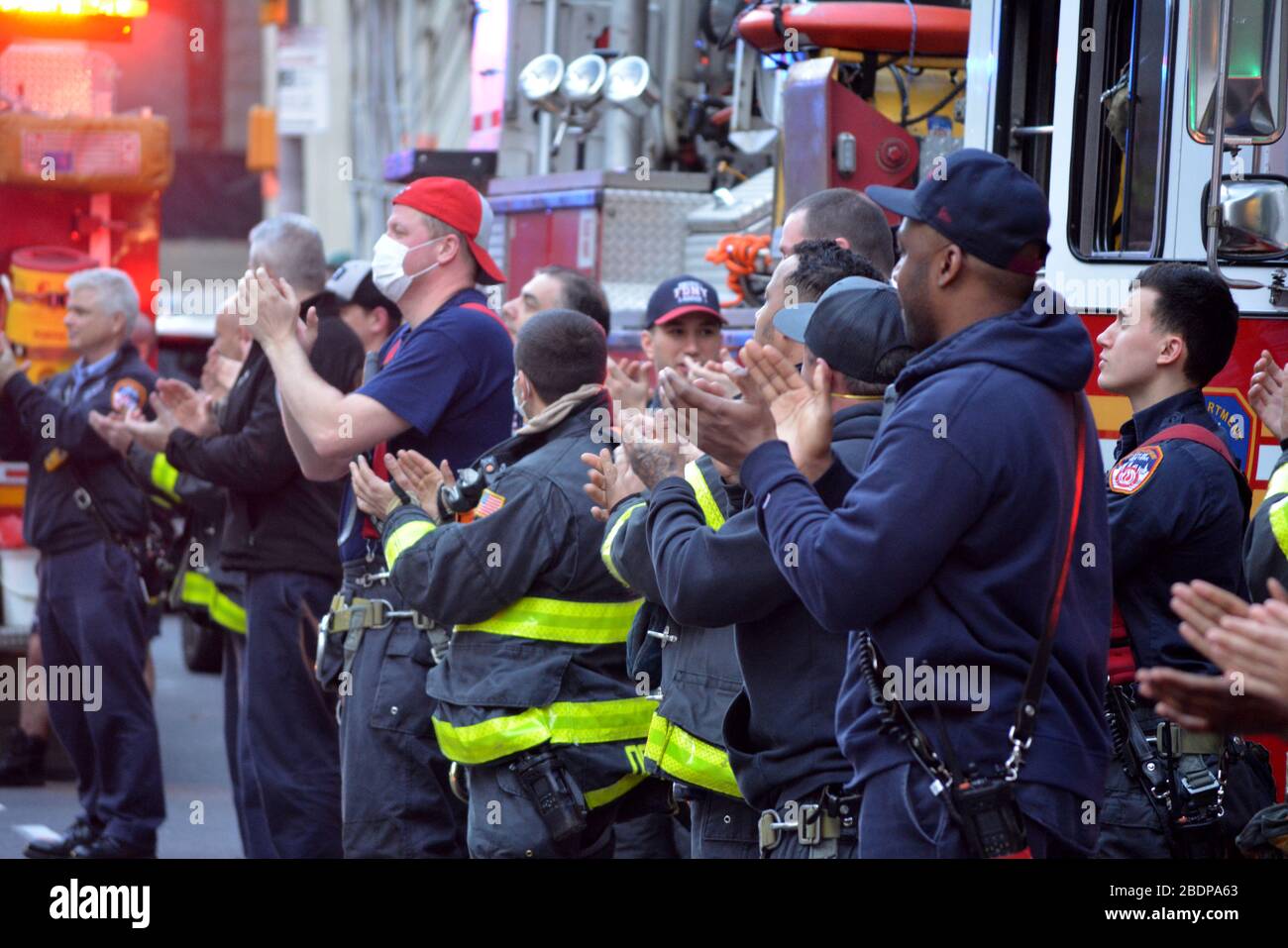 Members of the FDNY across from New York Presbyterian Hospital thanking the staff for their work fighting the coronavirus pandemic in Lower Manhattan. Stock Photo