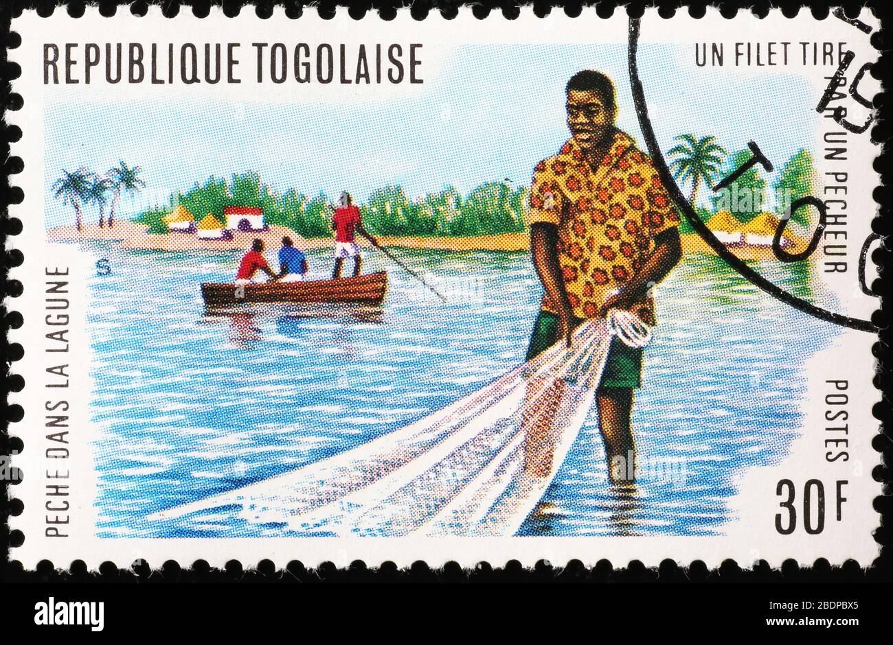 African fisherman on postage stamp of Togo Stock Photo