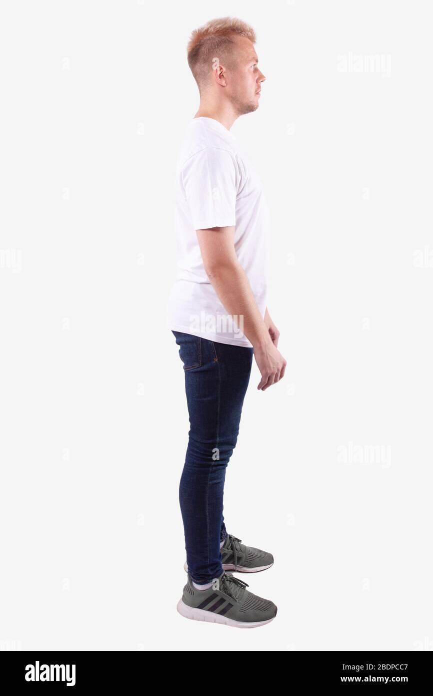 Man stands sideways to camera and looks ahead. Full length. White  background Stock Photo - Alamy