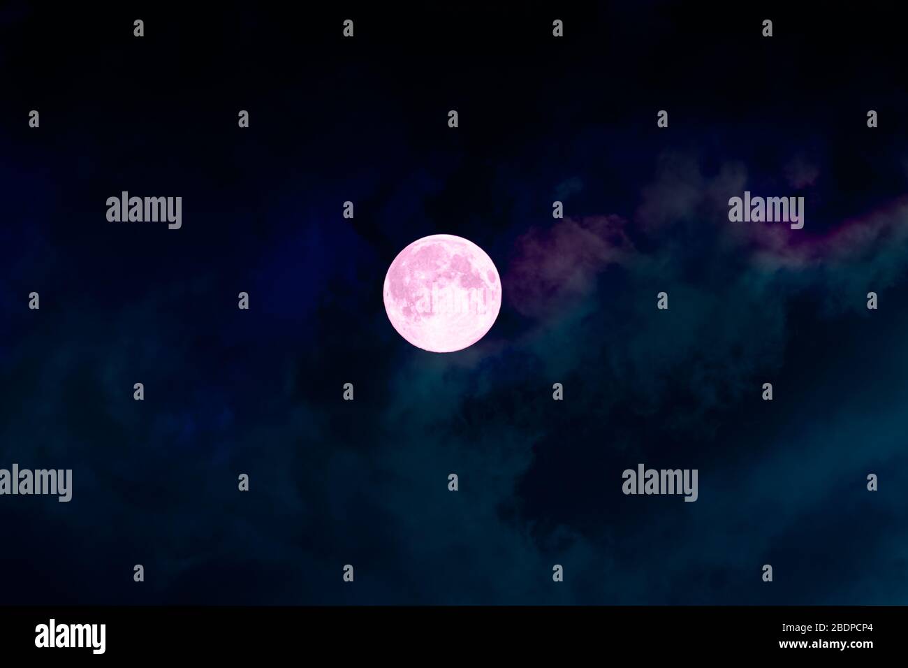 Big full bright pink purple magic moon with colorful clouds. Perigee night, lunar closest to Earth Stock Photo