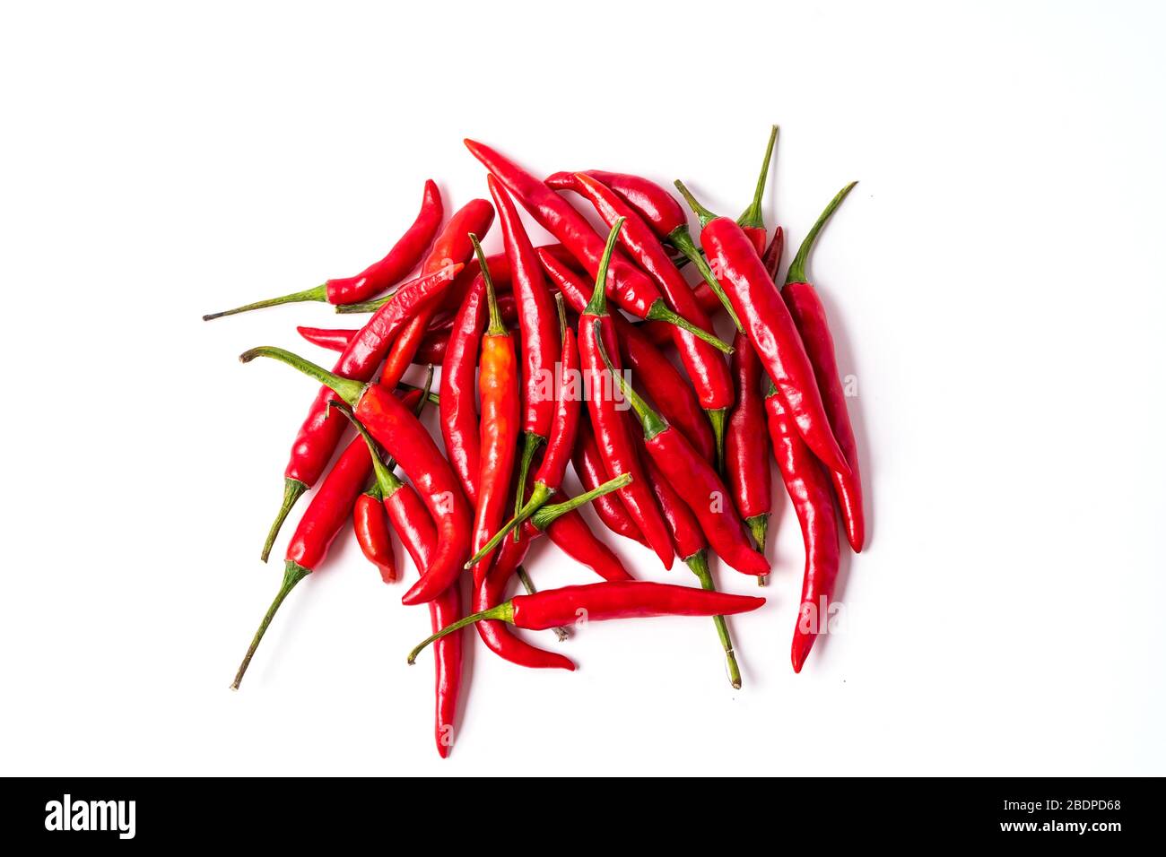 Flat lay red fresh chili peppers pile isolated on white Stock Photo - Alamy