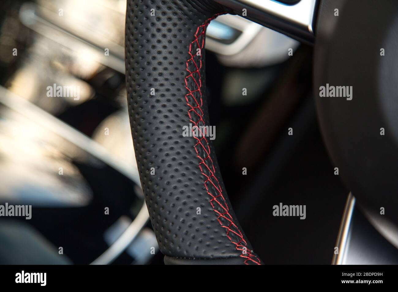 Red stitching on steering wheel Stock Photo Alamy