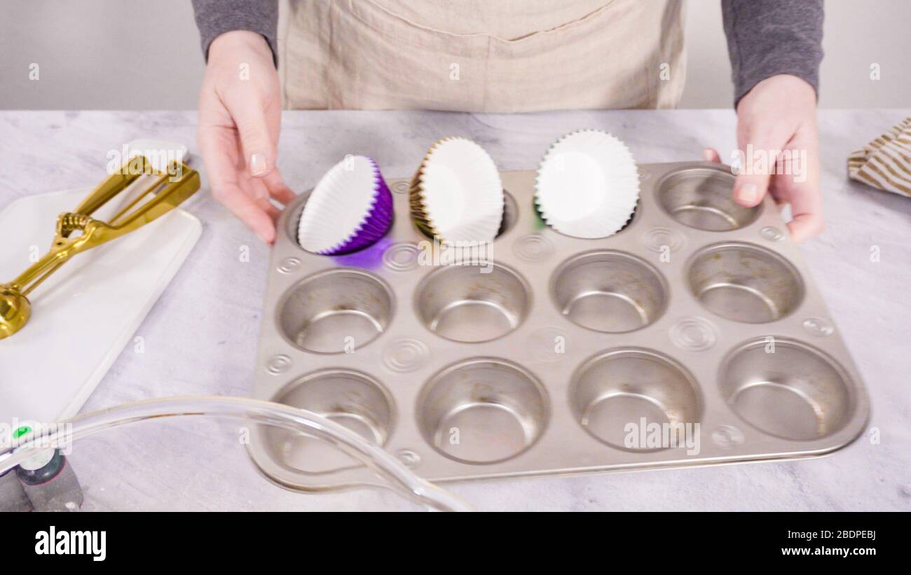 Step by step. Lining cupcake pan with foil cupcake cups Stock Photo Alamy