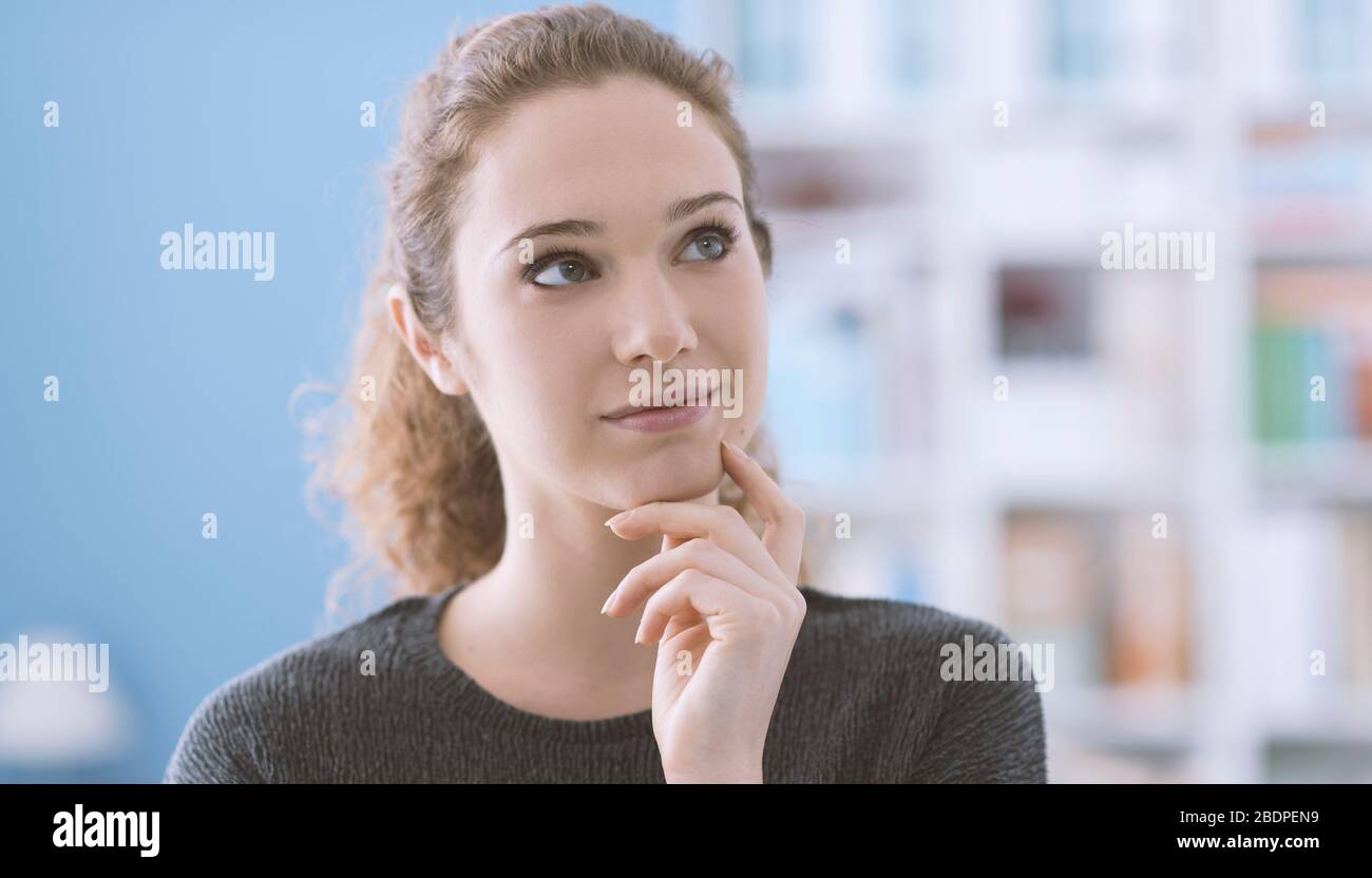 Beautiful girl thinking with hand on chin and smiling, creativity and ...