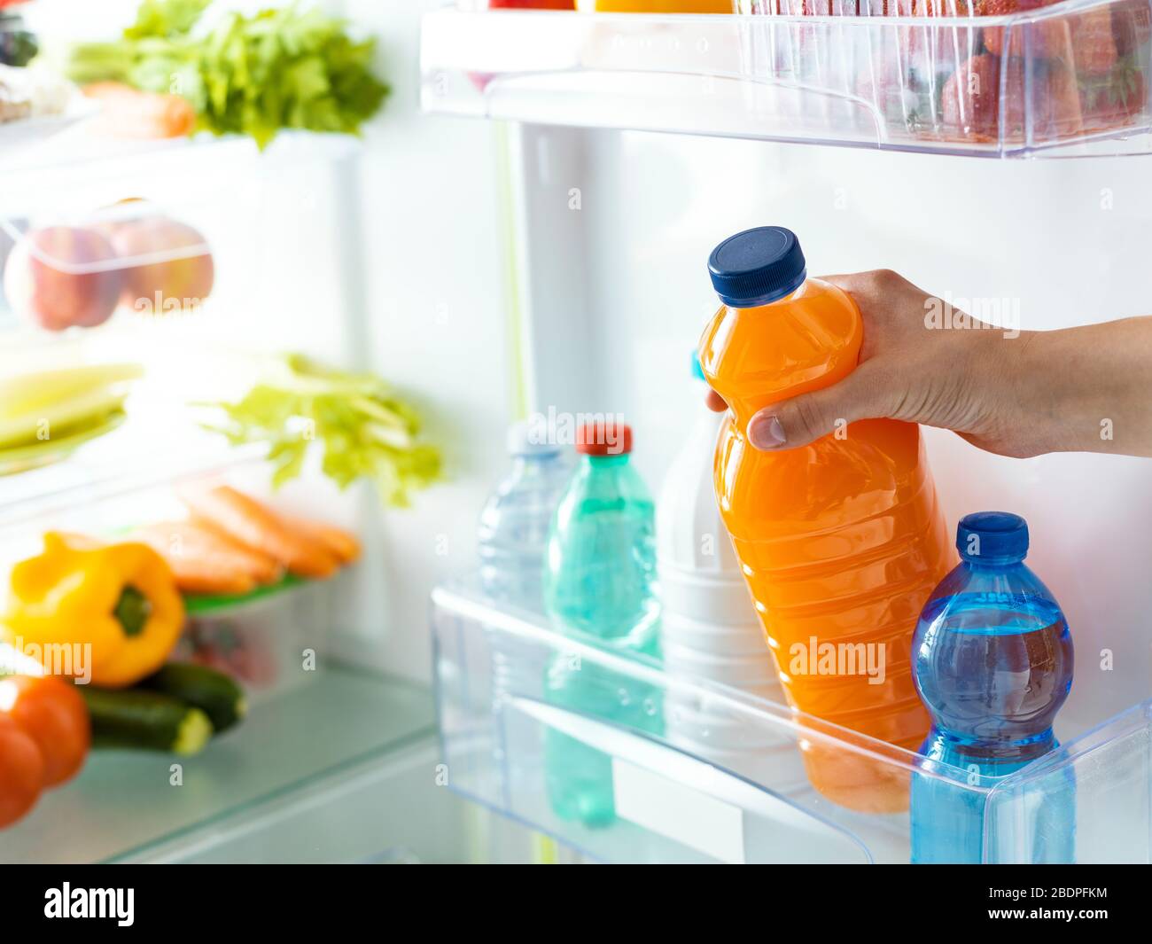 Orange juice bottles in refrigerator Stock Photo - Alamy