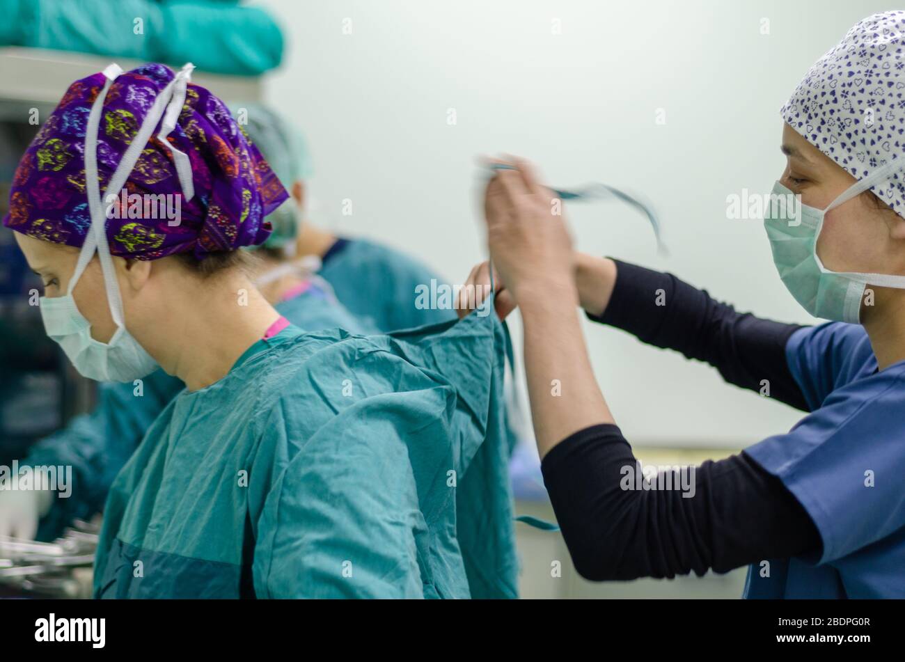 The nurse or doctor is wearing sterile surgical gown preoperative. Stock Photo