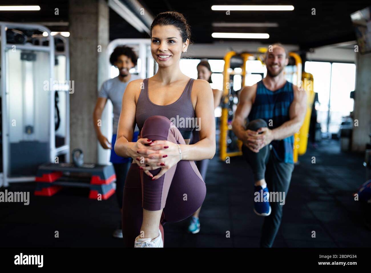 Fitness, sport, training and lifestyle concept. Group of people exercising in gym Stock Photo