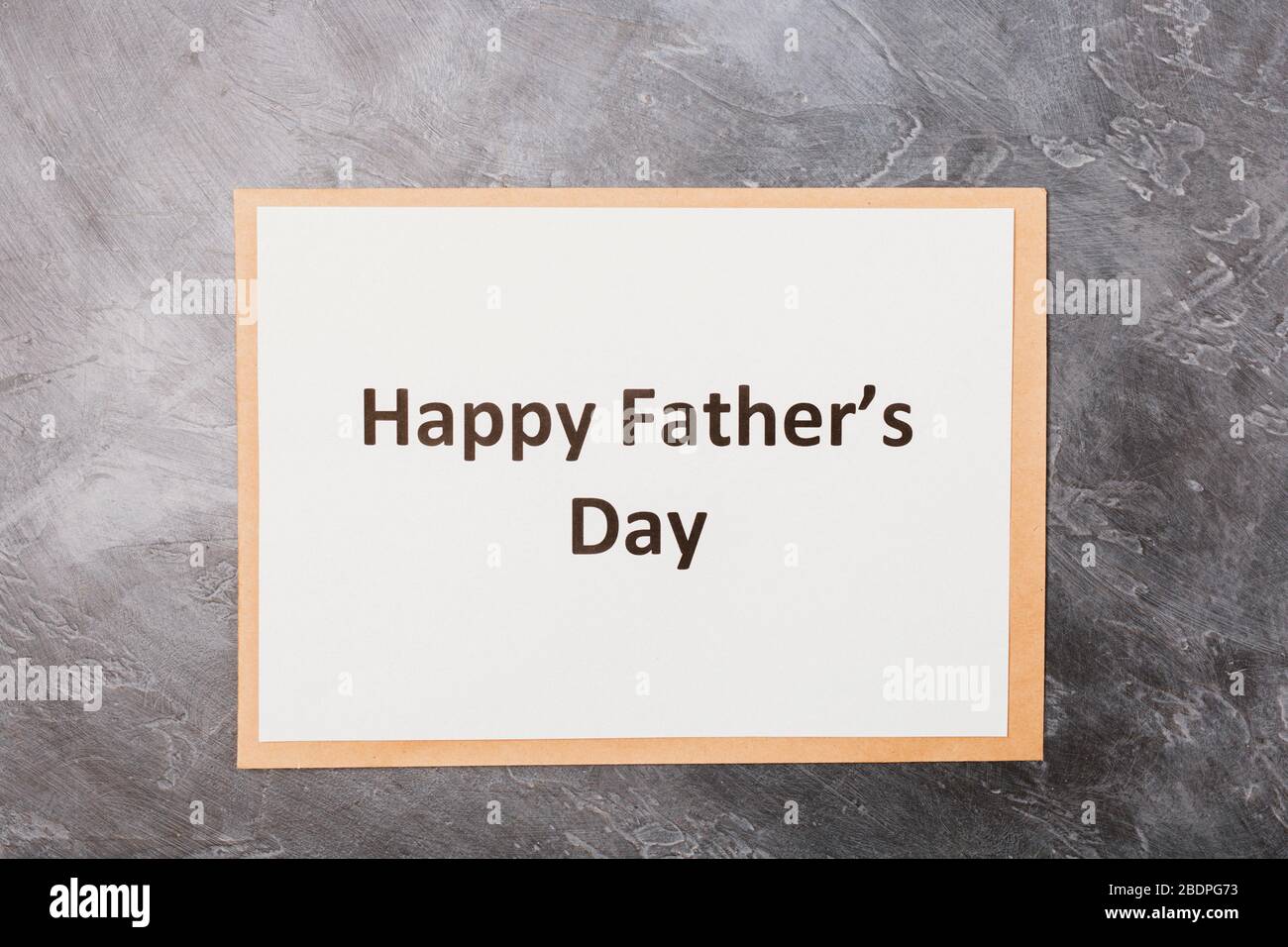 Happy Father's Day text on craft envelope on grey background. Free space. Space for text. Father's day holiday concept.  Stock Photo