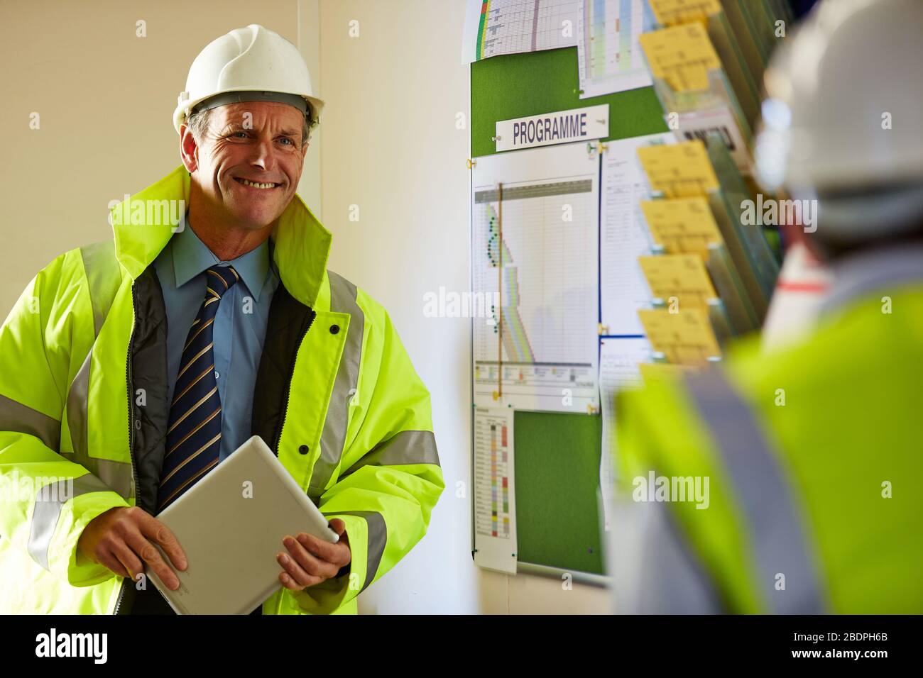 Portrait of a successful mature male architect holding a digital tablet at site Stock Photo