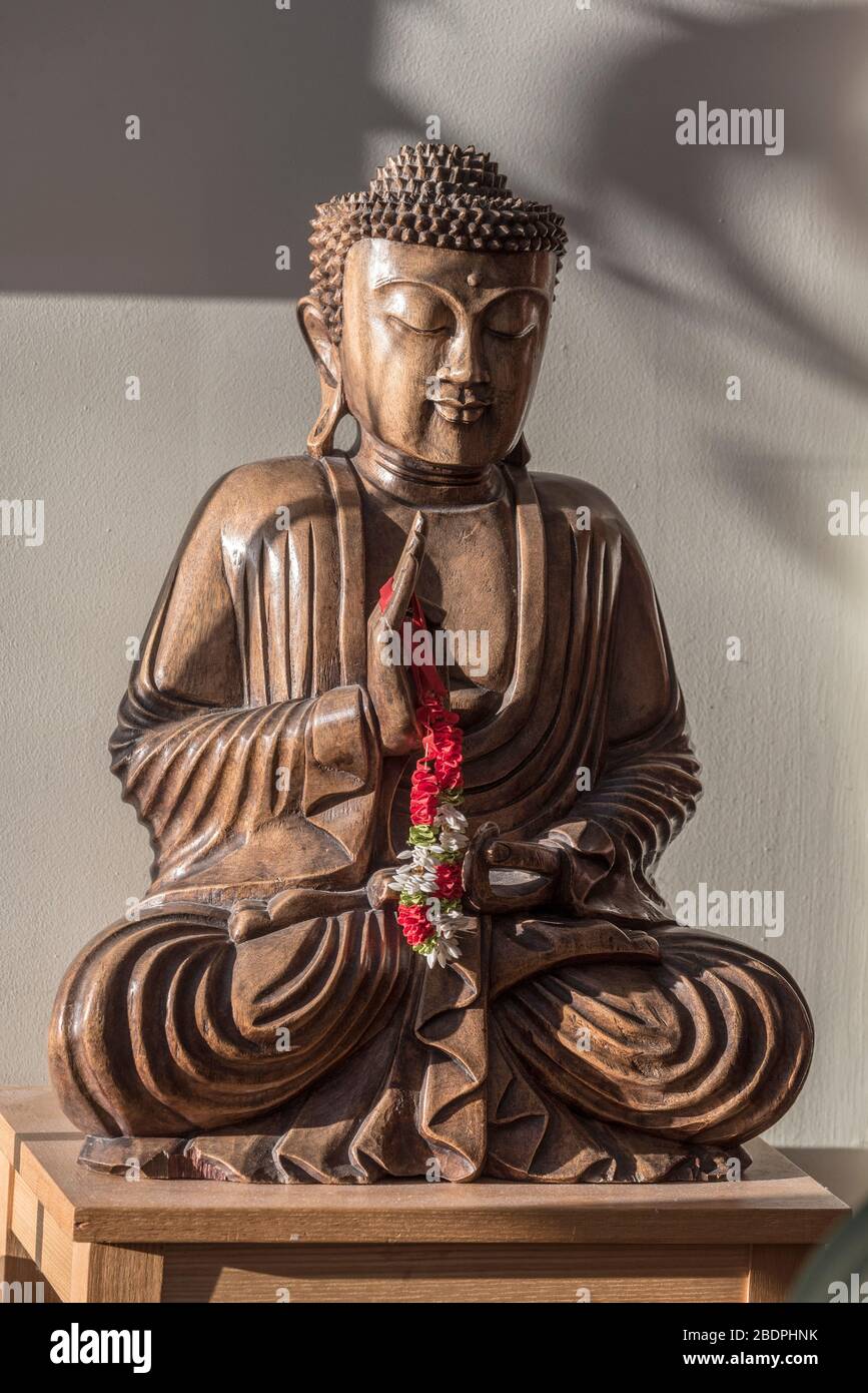 A statue of Buddha at prayer Stock Photo Alamy