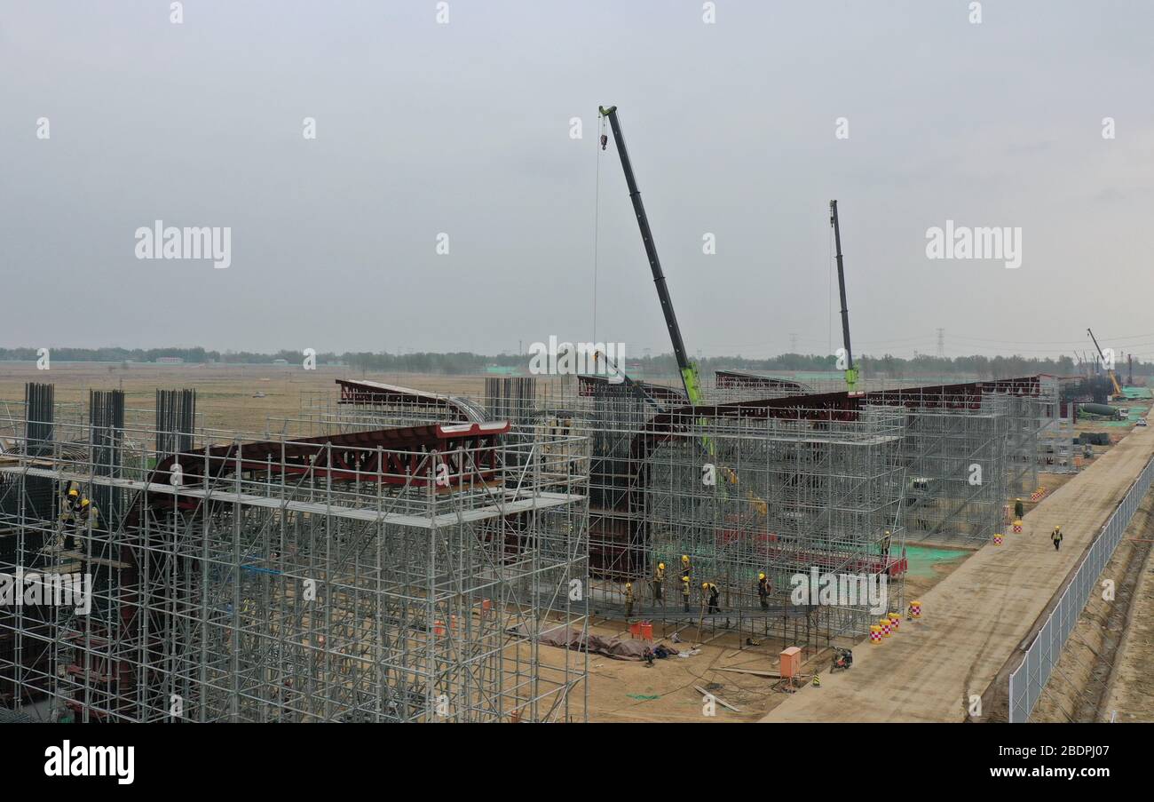 Xiongan. 9th Apr, 2020. Aerial photo taken on April 9, 2020 shows people working at the construction site of the Langouwa grand bridge of the Beijing-Xiongan expressway in Xiongan New Area, north China's Hebei Province. The Beijing-Xiongan expressway which connects China's capital city of Beijing and Xiongan New Area, located about 100 km southwest of Beijing, is under construction in an orderly manner and expected to open to traffic by 2021. Credit: Yang Shiyao/Xinhua/Alamy Live News Stock Photo