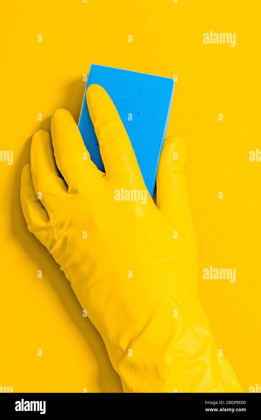 Hand in rubber glove with wipe for cleaning wipes the surface from dust