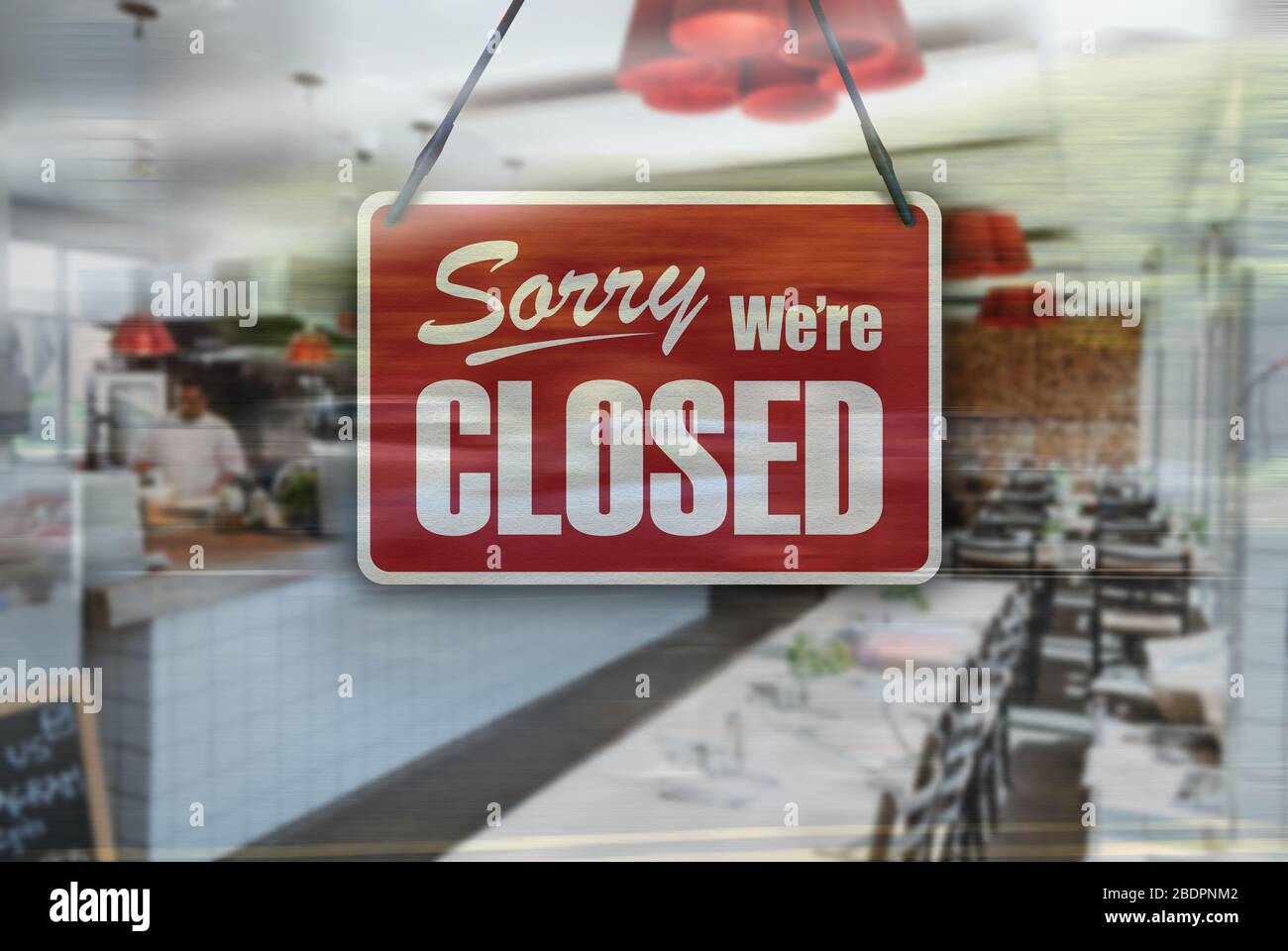 A business sign that says 'Sorry, We're Closed' on Cafe / Restaurant window. Stock Photo