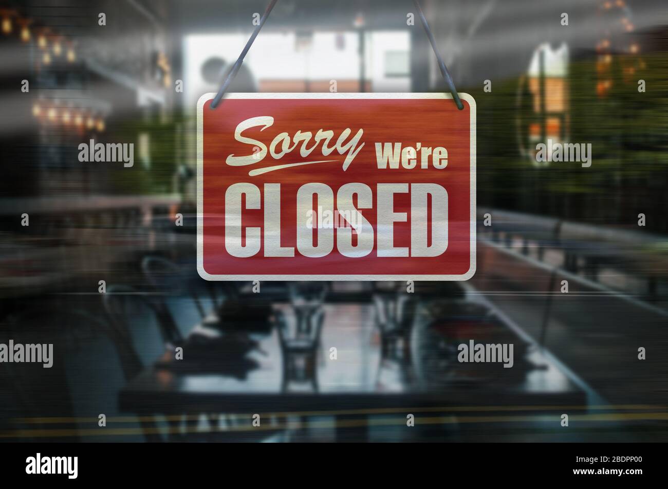 A business sign that says 'Sorry, We're Closed' on Cafe / Restaurant window. Stock Photo