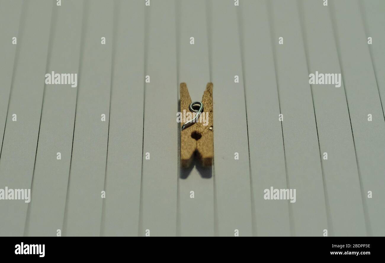 Side view of a wooden clothespin on a white lined surface Stock Photo Alamy