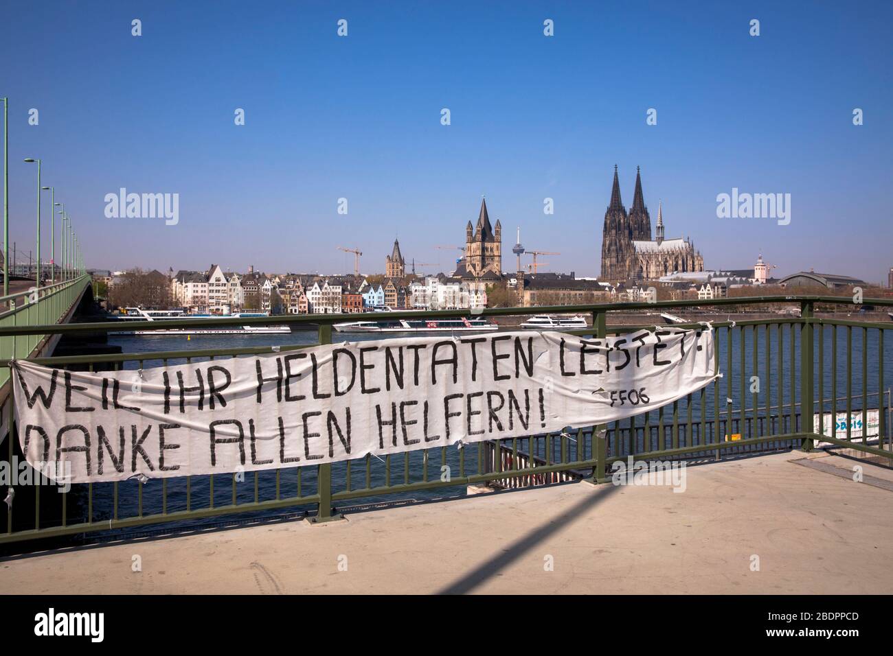 Coronavirus / Covid 19 outbreak, April 8th. 2020. A banner at the Deutzer bridge thanks the helpers, view to the cathedral, Cologne, Germany.  Coronav Stock Photo