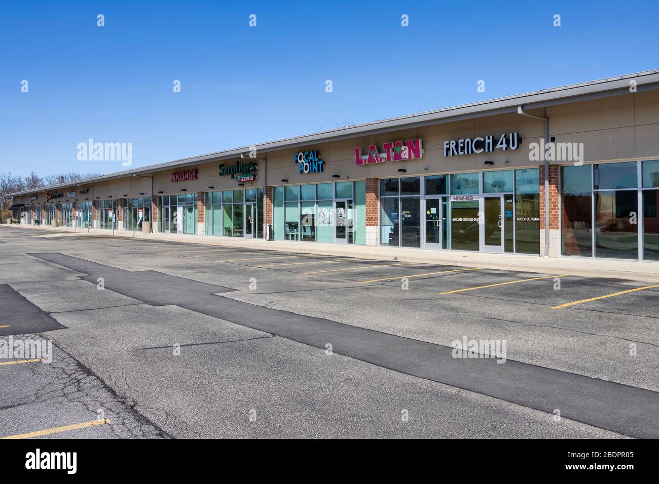 Streamwood, Illinois, USA. An empty parking lot provides a ghost town-like  appearance to a strip mall during the coronavirus pandemic Stock Photo -  Alamy