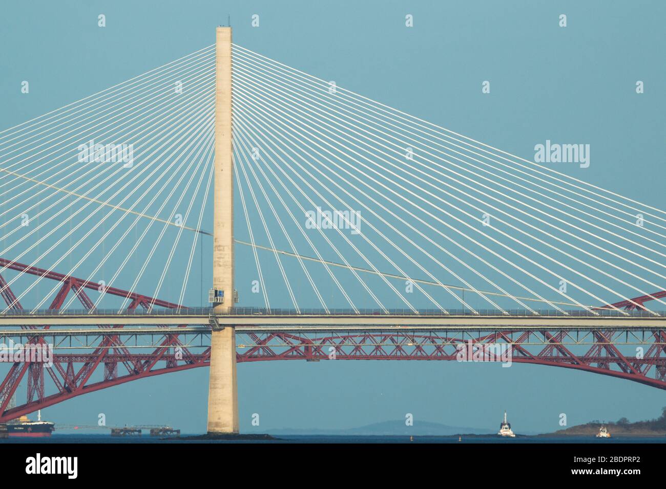 Grangemouth, UK. 8 April 2020. Pictured: The Queensferry Crossing - Scotland’s newest bridge and the 3rd Firth of Forth crossing which connects Fife and Lothian carrying the M90 Motorway spanning 1.7 miles (2.7km) structure is the longest three-tower, cable-stayed bridge in the world and also by far the largest to feature cables which cross mid-span. This innovative design provides extra strength and stiffness, allowing the towers and the deck to be more slender and elegant. Credit: Colin Fisher/Alamy Live News. Stock Photo