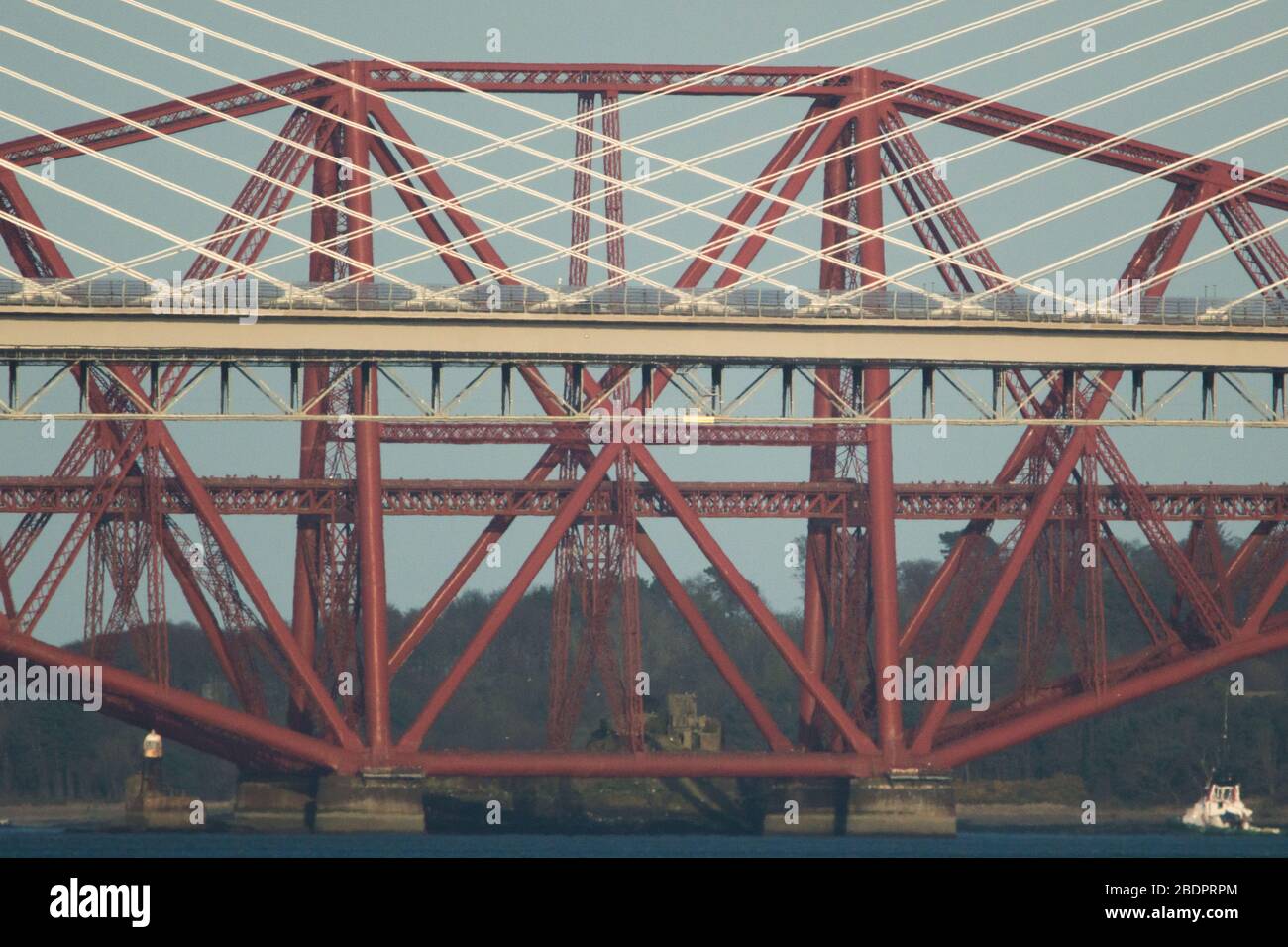 Grangemouth, UK. 8 April 2020.  Pictured: The Queensferry Crossing - Scotland’s newest bridge and the 3rd Firth of Forth crossing which connects Fife and Lothian carrying the M90 Motorway spanning 1.7 miles (2.7km) structure is the longest three-tower, cable-stayed bridge in the world and also by far the largest to feature cables which cross mid-span. This innovative design provides extra strength and stiffness, allowing the towers and the deck to be more slender and elegant. Credit: Colin Fisher/Alamy Live News. Stock Photo