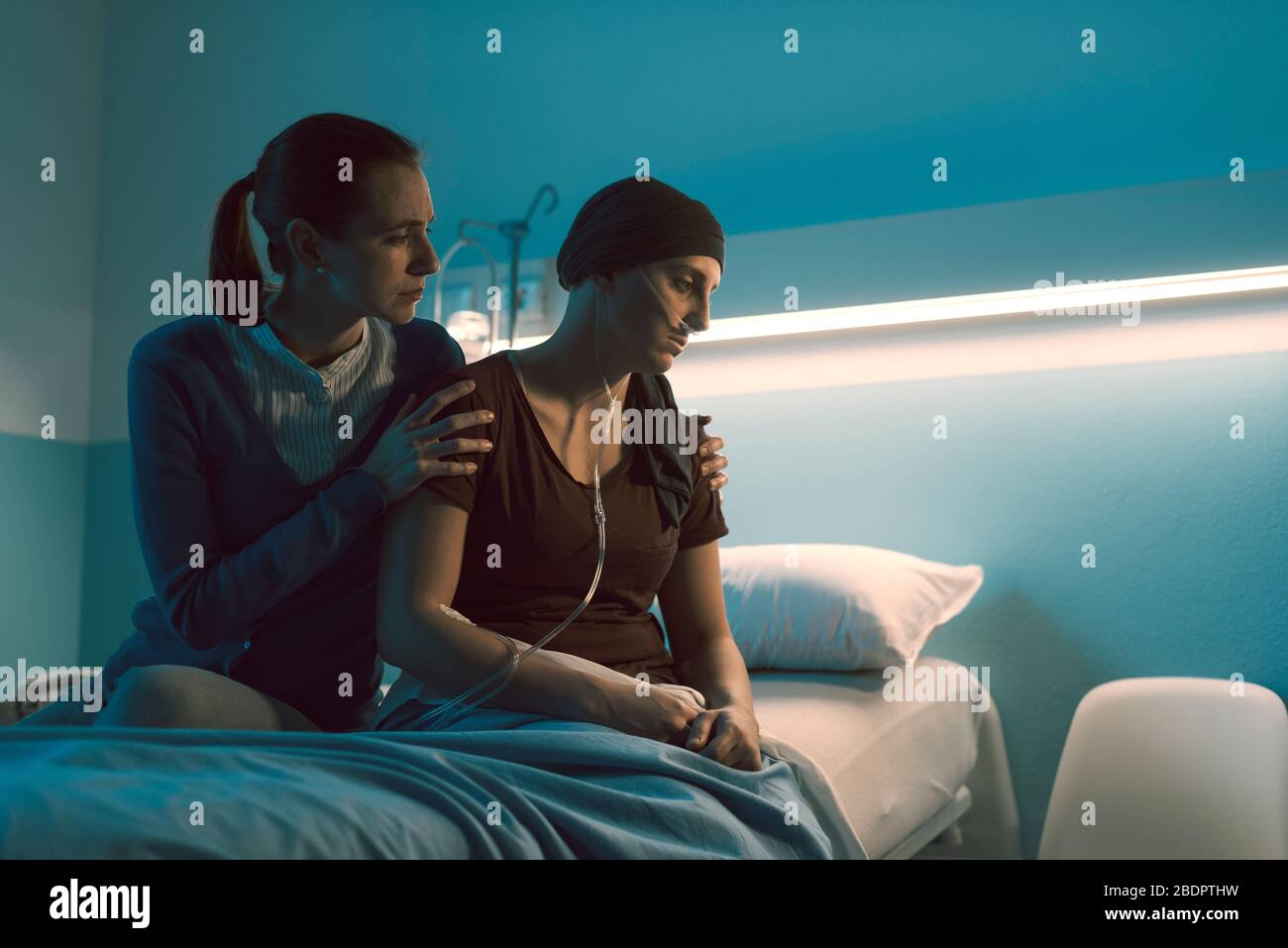 Caring woman assisting her sick friend with cancer at the hospital, she is  comforting her Stock Photo - Alamy