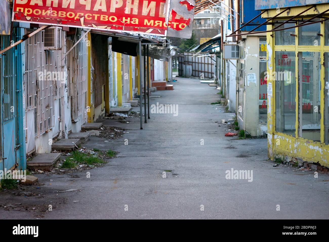 View of empty market lane and abandoned and deserted shops and small businesses closed down due to economic and industrial decline in the area in Sofia, Bulgaria, Eastern Europe as of April 2020 Stock Photo
