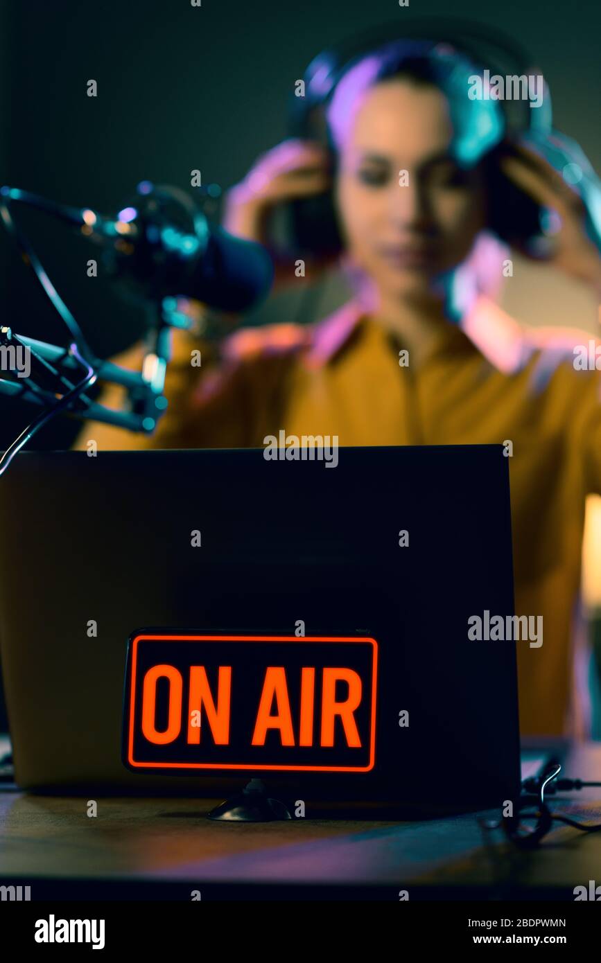 Young radio host getting ready for broadcasting, she is wearing