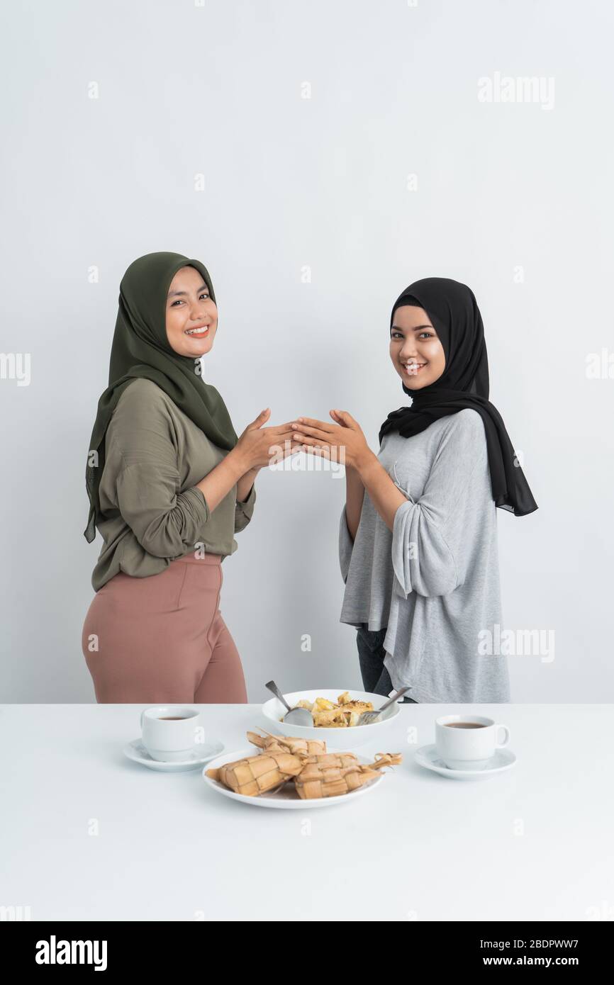 gesture of woman muslim apologizing together on ramadan kareem Stock Photo