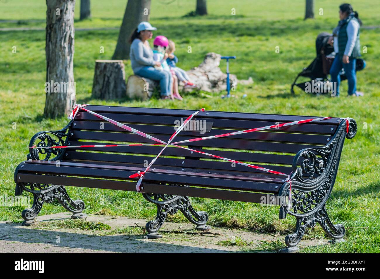 London, UK. 09th Apr, 2020. The benches may be taped off, but there is always somewhere else to sit - Clapham Common is pretty quiet now Lambeth Council has taped up all the benches. The 'lockdown' continues for the Coronavirus (Covid 19) outbreak in London. Credit: Guy Bell/Alamy Live News Stock Photo