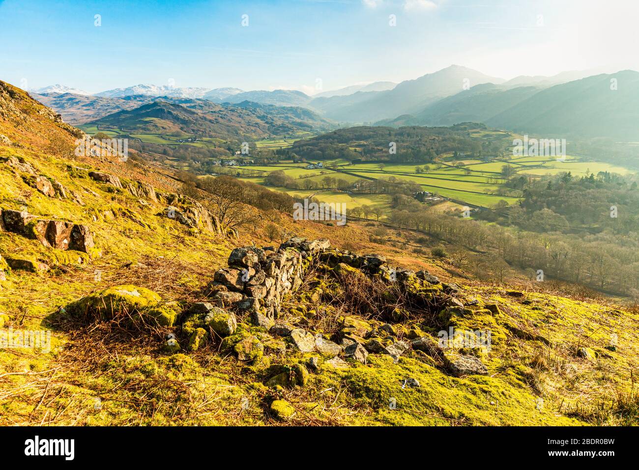 View over Eskdale in the English Lake District from Hollinghead Bank. Skyline fells include Bowfell, Crinkle Crags and Harter Fell. Stock Photo