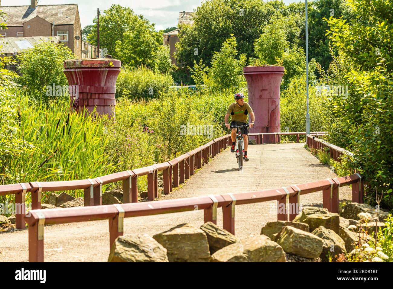 Cyclist on car free path at Accrington, Lancashire, part of the Hyndburn Greenway Stock Photo