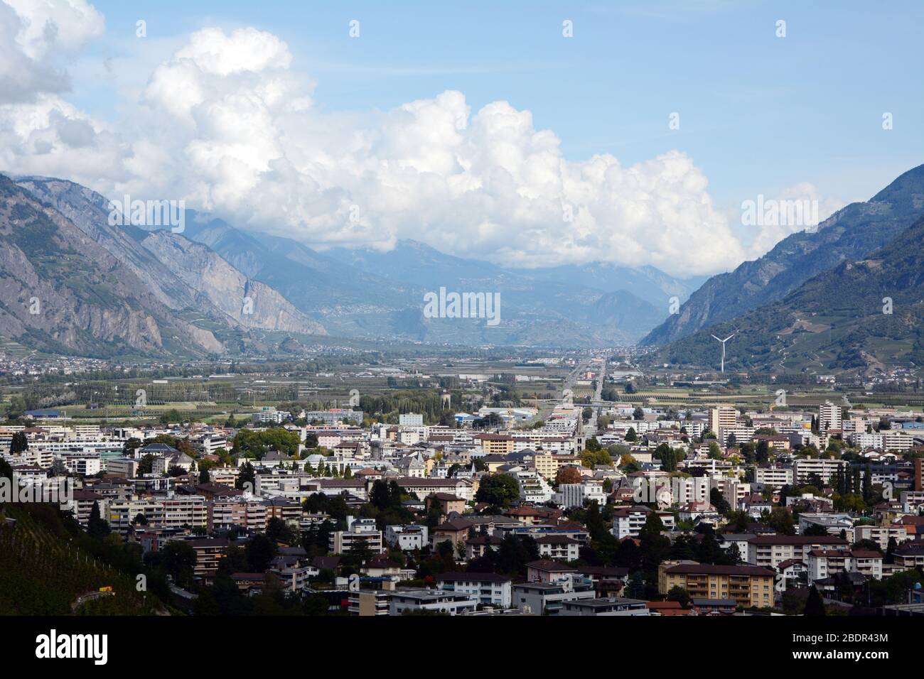 The Swiss city of Martigny and surrounding vineyards, beneath the Alps, in the Rhone River Valley, canton of Valais, Switzerland. Stock Photo