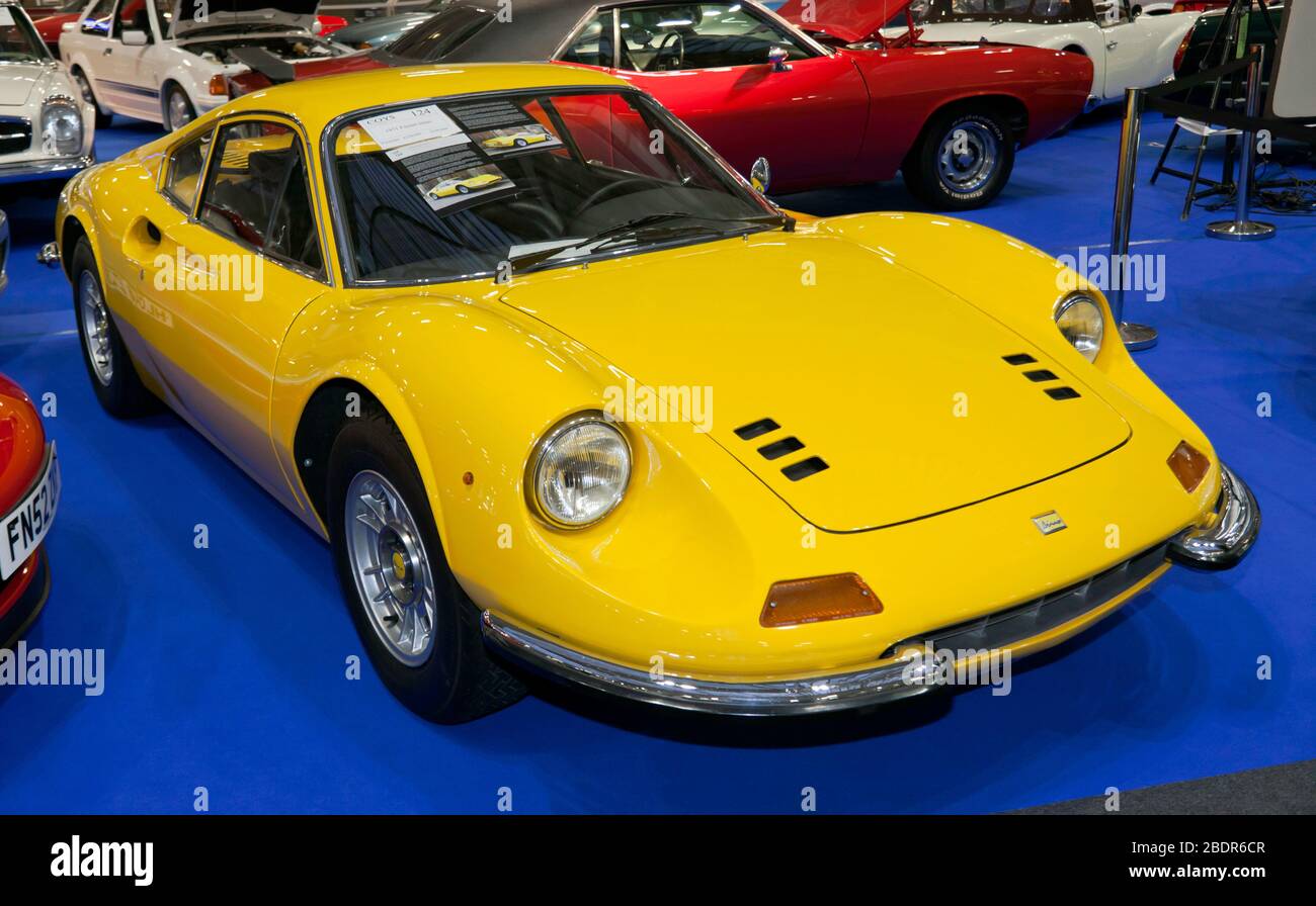 Three-quarters Front view of a Yellow, 1970 Ferrari 246 GT 'Dino',on display in the Coys Auction Zone, of the 2020 London Classic Car Show Stock Photo