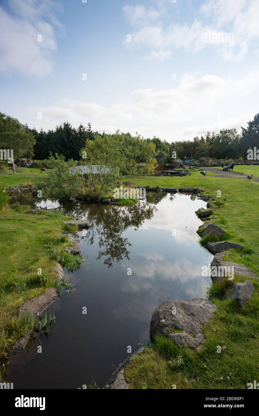 A bridge over a small pond at Reykjavík Botanical Garden, Iceland Stock Photo