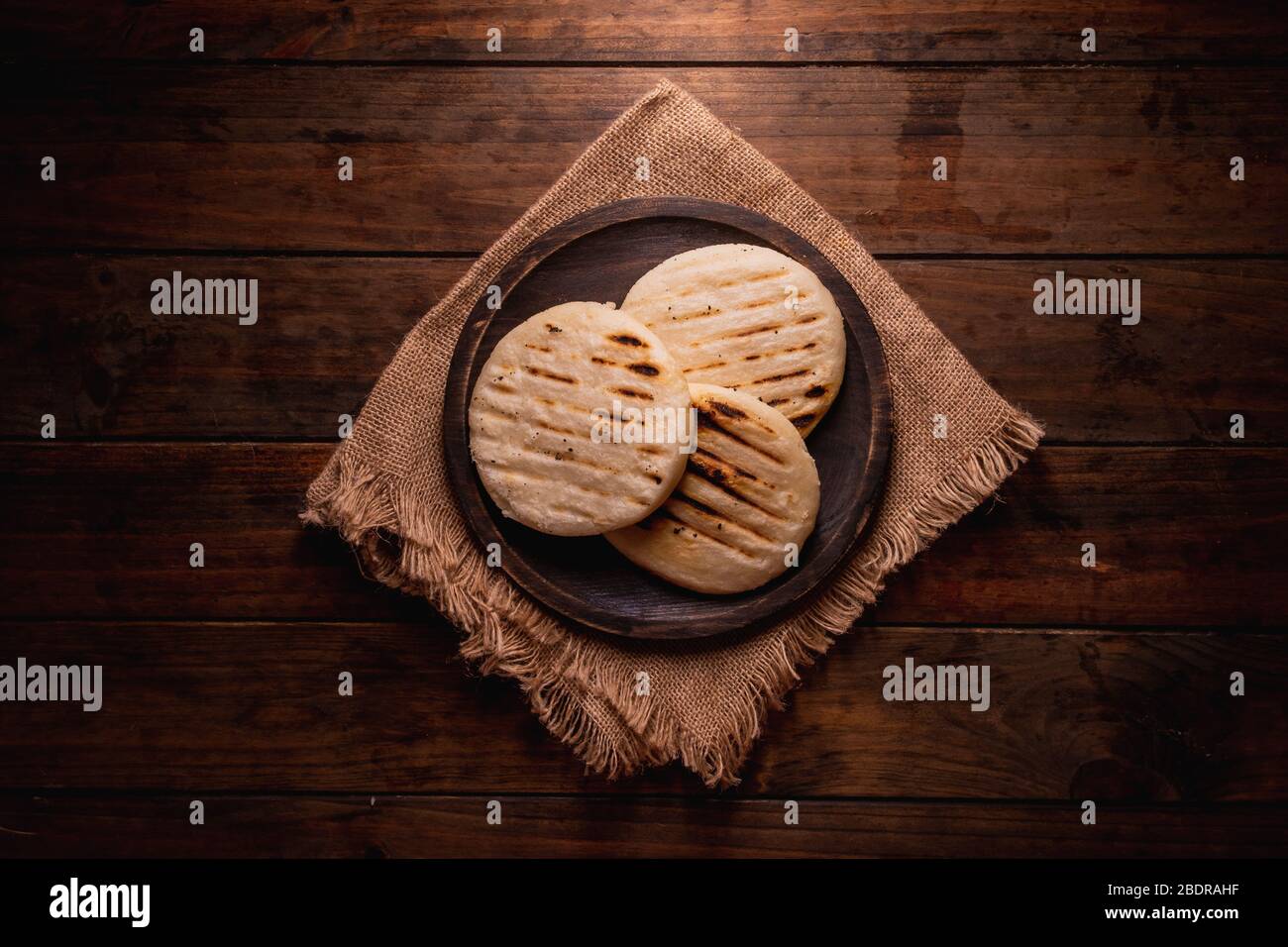 Top view of a group of traditional Latin American arepas on a wooden ...