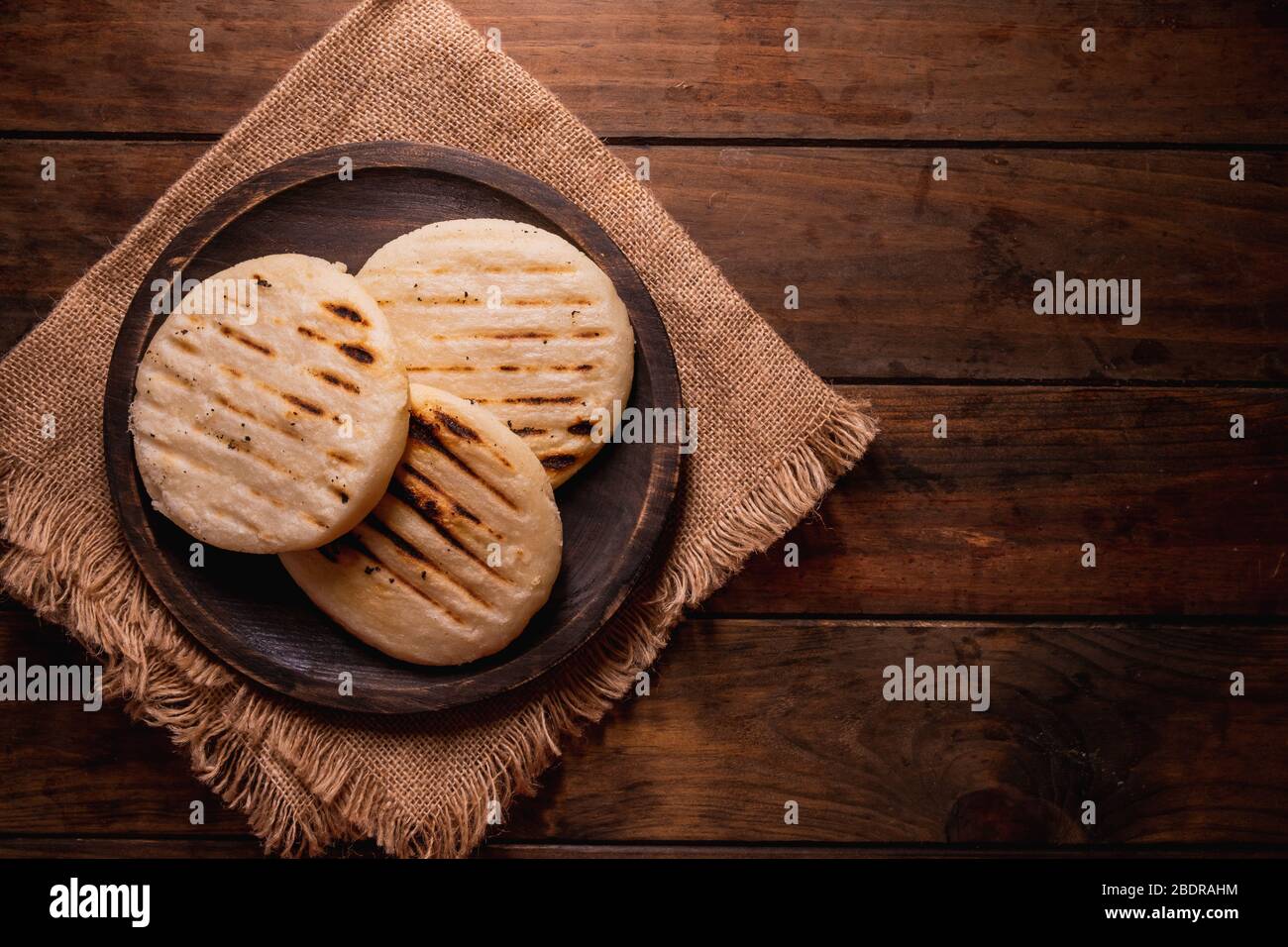 Top view of a group of traditional Latin American arepas on a wooden ...