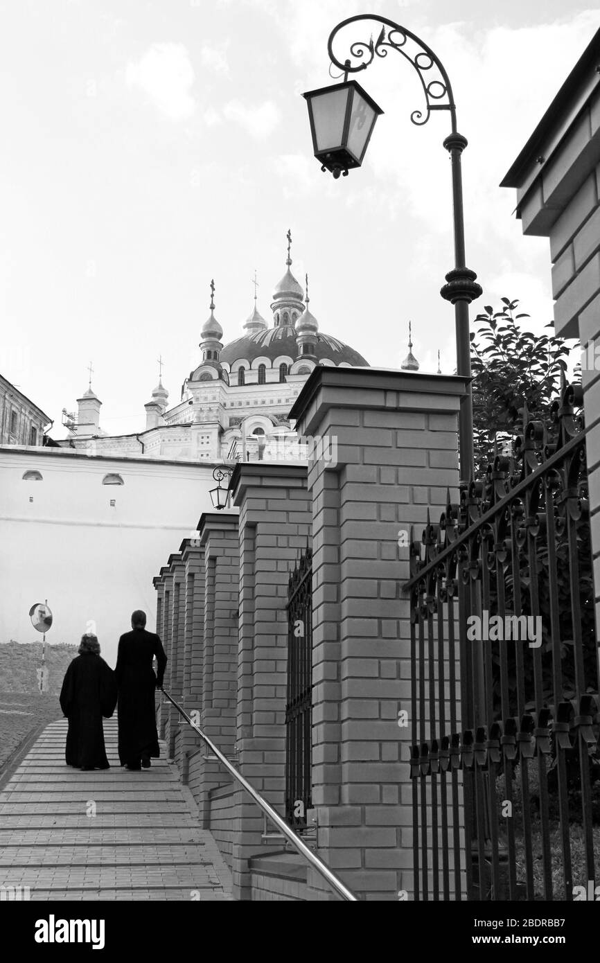 Lantern, two priests and church.Kiev-Pechersk Lavra monastery in Kyiv. Ukraine Stock Photo