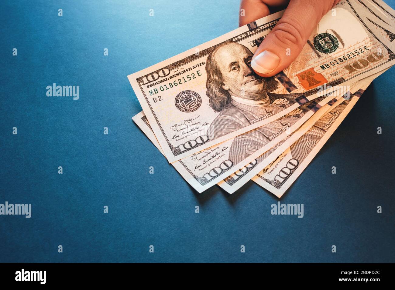 American cash dollars. Hundred-dollar bills in hand. Stock Photo