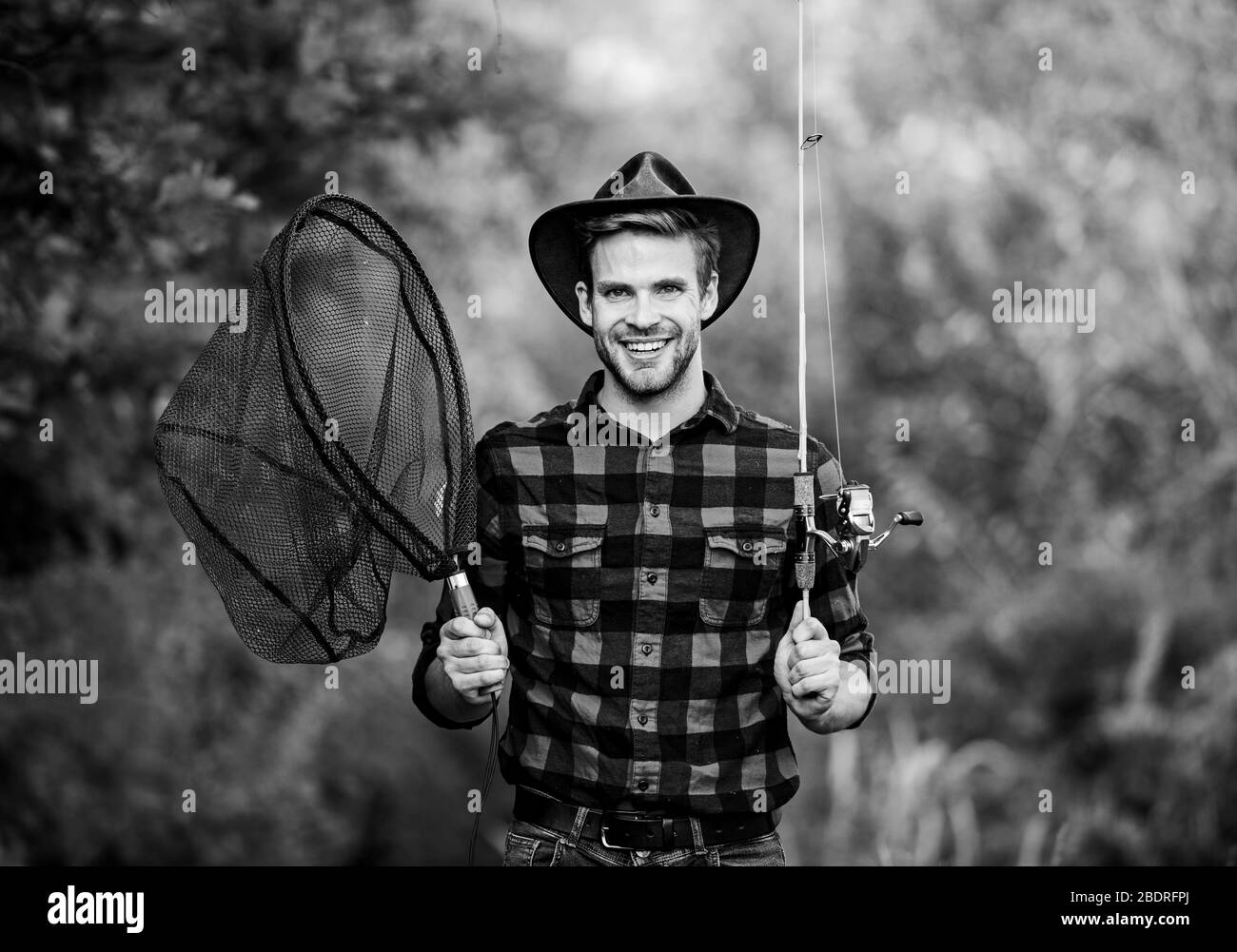 Gone Fishing. fisherman with fishing rod. happy man in cowboy hat. western  portrait. Vintage style man. Wild West retro cowboy. fly fishing. man  checkered shirt on ranch. fisher hold fish net. hobby