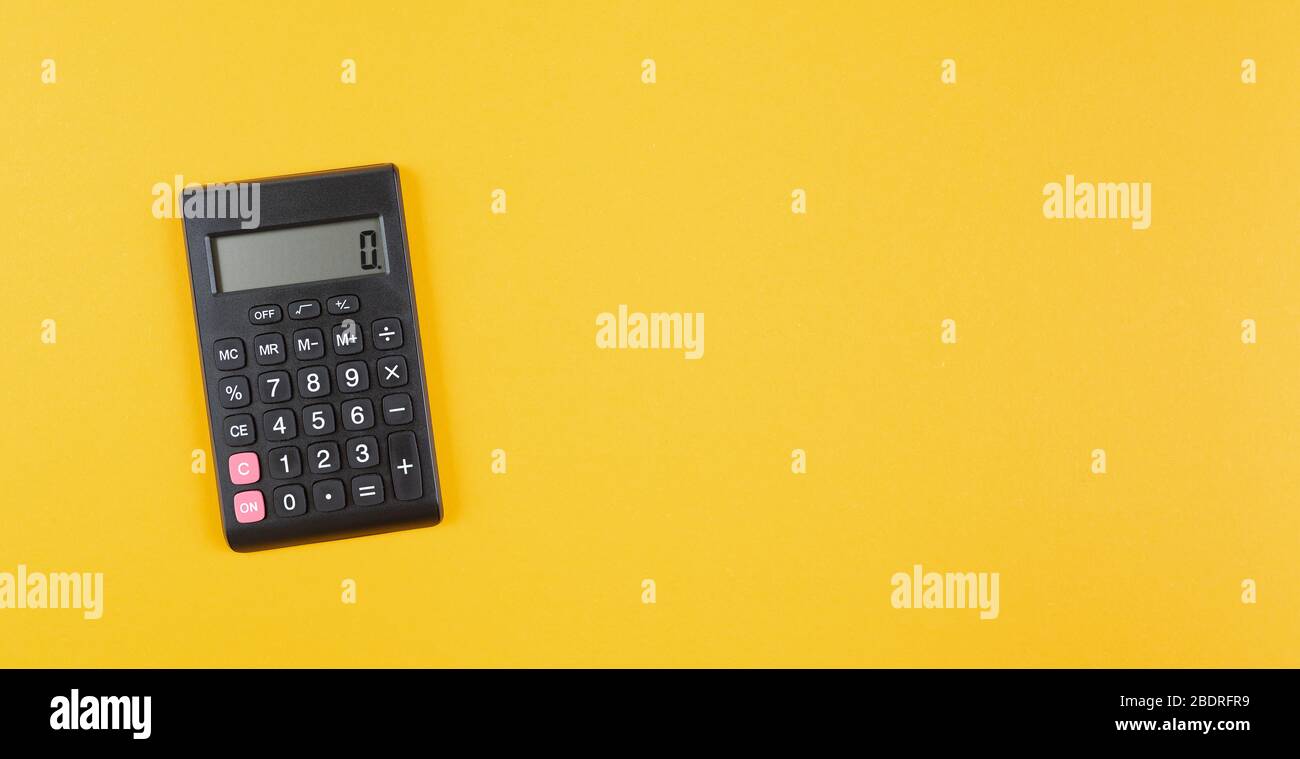 top view of pocket calculator on orange background, business calculation and finance concept Stock Photo