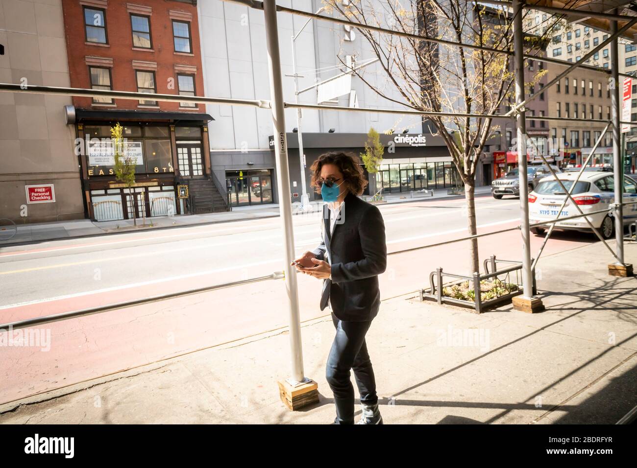 A man walks wearing his mask in Chelsea in New York on Wednesday, April 1, 2020 due to COVID-19. (© Richard B. Levine) Stock Photo