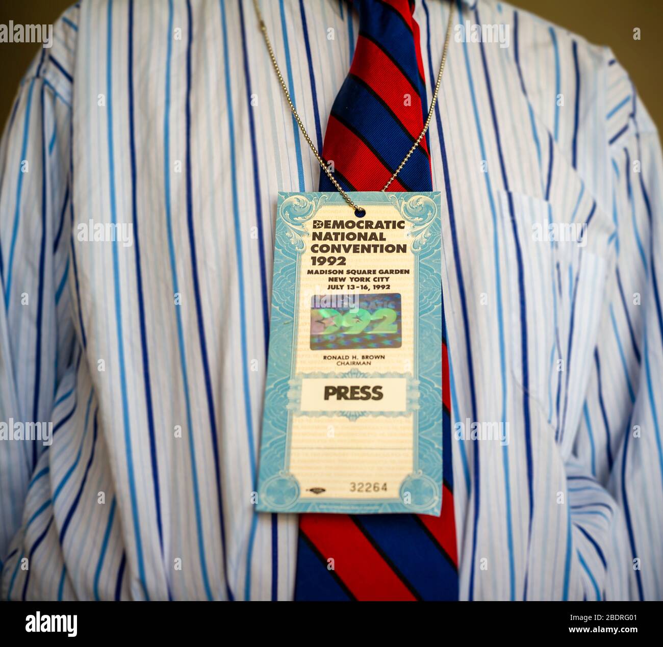 A man wears his Democratic National Convention press identification from the 1992 convention, held in New York in this photo illustration on Thursday, April 2, 2020. The DNC has announced that it has pushed the 2020 Milwaukee convention to the week of August 17. (© Frances M. Roberts) Stock Photo