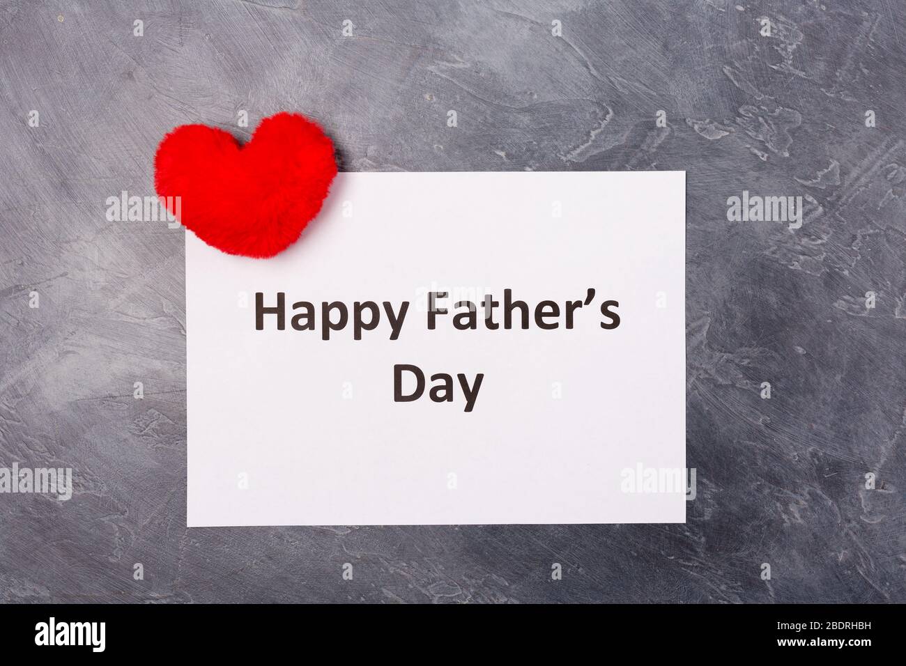 Happy Father's Day text on grey background with red heart. Free space. Space for text. Father's day holiday concept.  Stock Photo