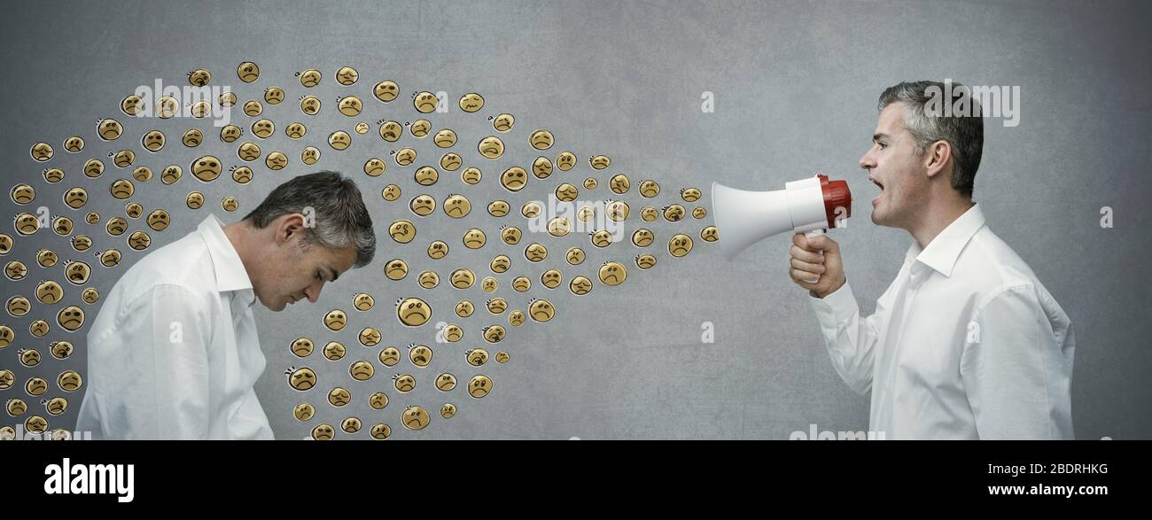 Confident man shouting with a megaphone and spreading his message, advertising and communication concept Stock Photo