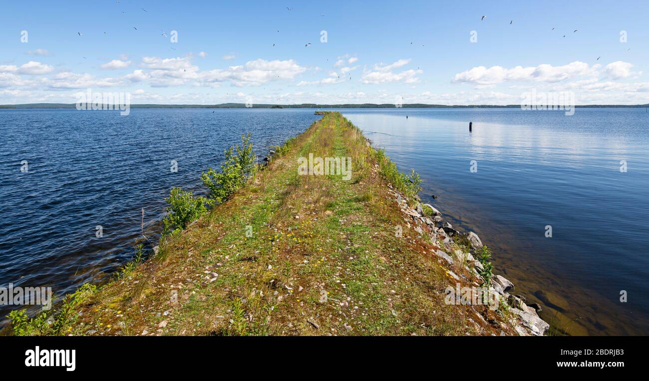 Breakwater creates a calm area behind it at lake Pohjois-Konnevesi , Finland Stock Photo