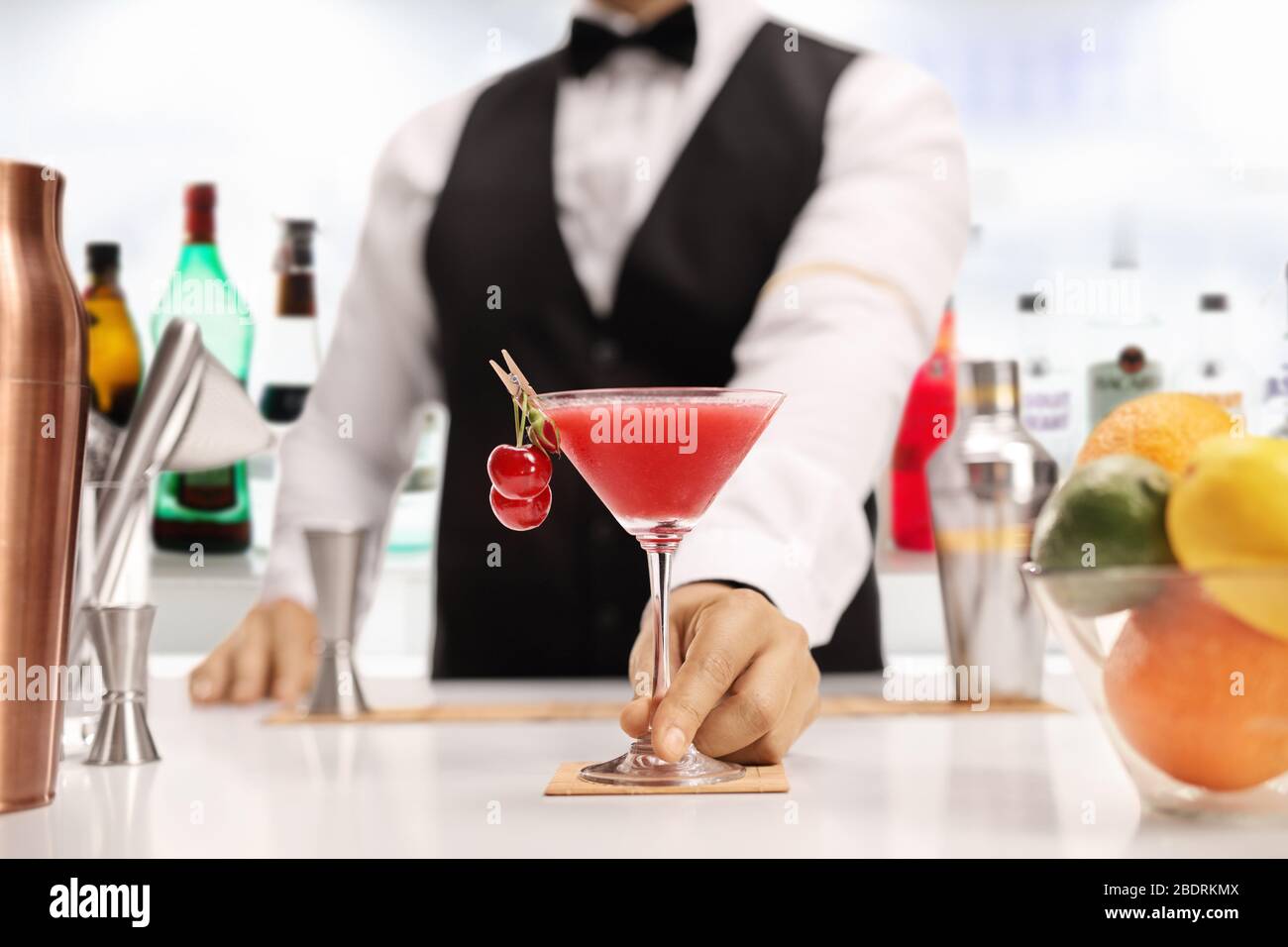 Bartender serving an alcoholic cocktail drink in a bar Stock Photo