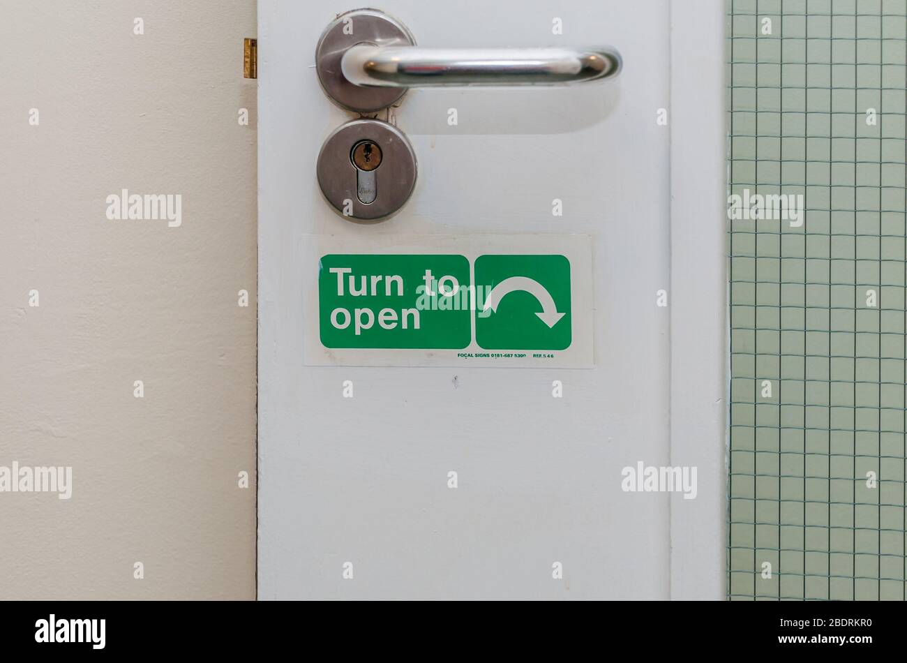 Turn to open turn arrow direction on a door Stock Photo Alamy