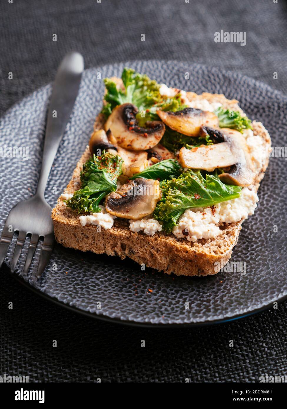 Vegan Ricotta, Mushrooms and Kale on Toast Stock Photo
